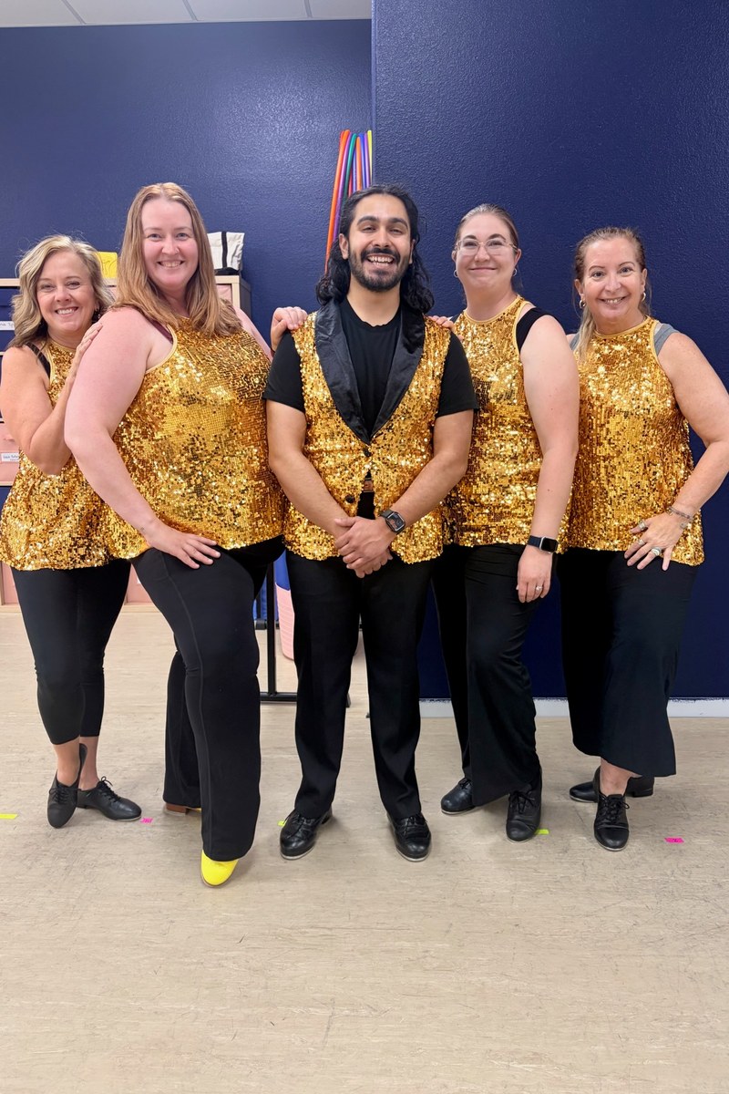 The B3 adult performance team in gold sequins, posed together in the studio