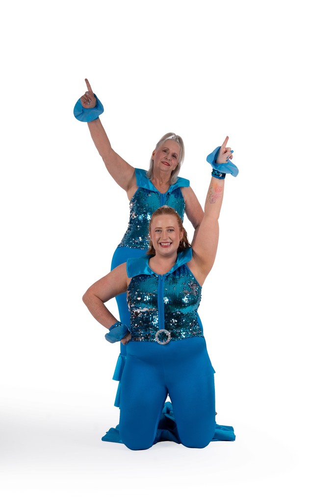 B3 Dance performers striking a lifted pose onstage in costume
